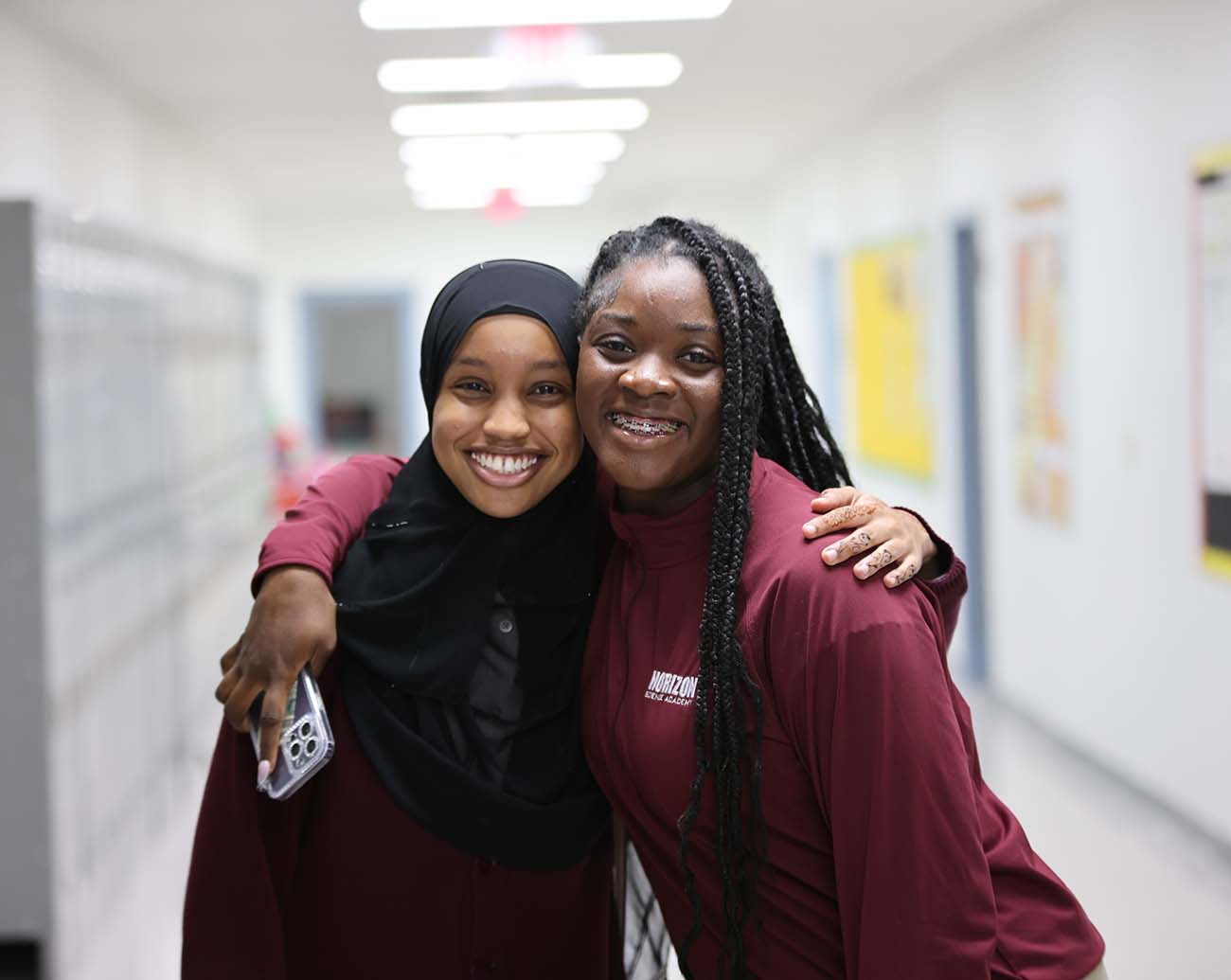Teacher or school staff member warmly interacting with a student outside